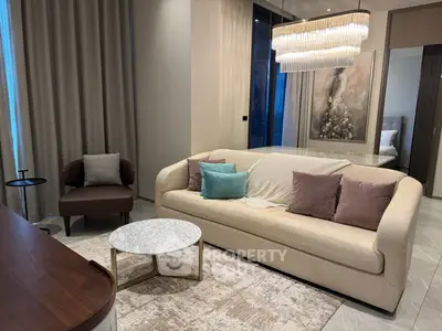 Elegant living room with modern sofa, chic chandelier, and stylish decor in a luxurious apartment.