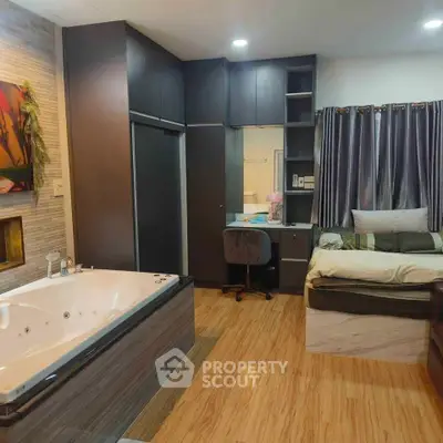 Luxurious bedroom with jacuzzi and modern decor, perfect for relaxation and comfort.