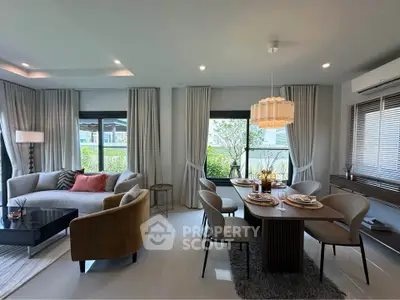 Elegant living and dining area with modern furniture and large windows in a stylish apartment.