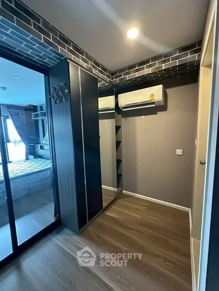 Modern bedroom with sliding glass doors and air conditioning unit