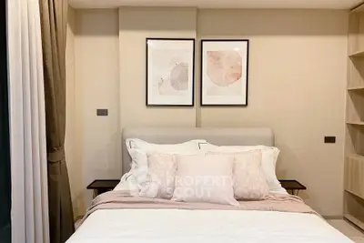 Cozy bedroom with elegant decor and soft lighting, featuring stylish artwork above the bed.