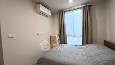 Cozy bedroom with air conditioning and natural light
