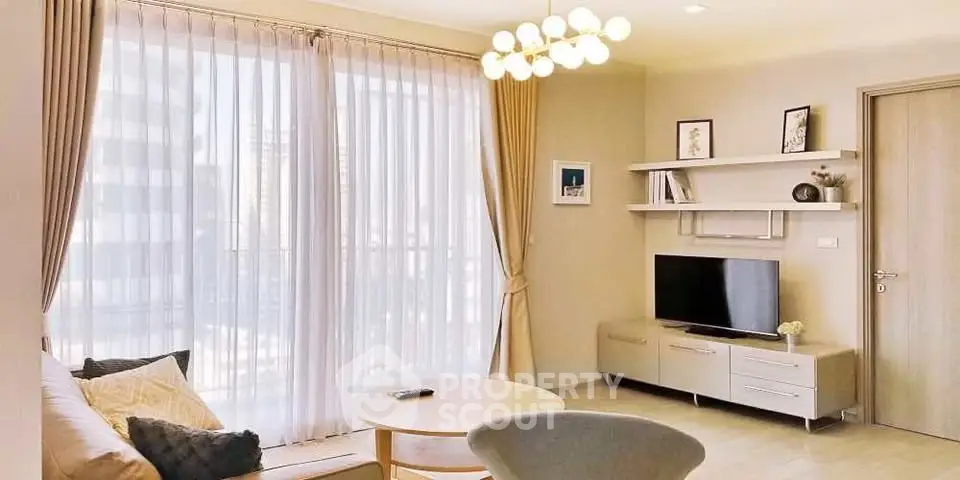 Bright and modern living room with large windows and stylish decor in a contemporary apartment.