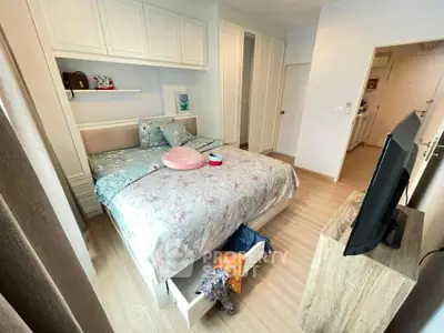 Cozy bedroom with stylish decor and ample storage in modern apartment
