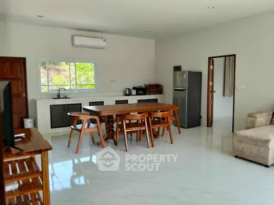 Spacious open-plan kitchen and dining area with modern appliances and natural light.