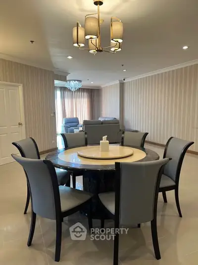 Spacious living room with elegant dining area and modern lighting