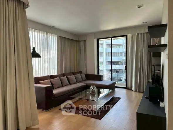 Spacious living room with modern decor and large windows for natural light.