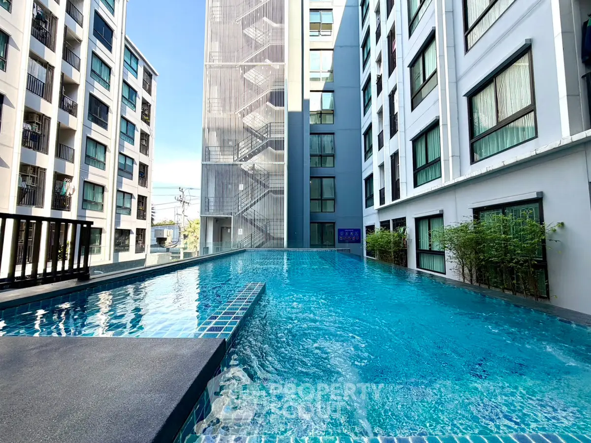 Modern apartment complex with a stunning rooftop pool and city views.