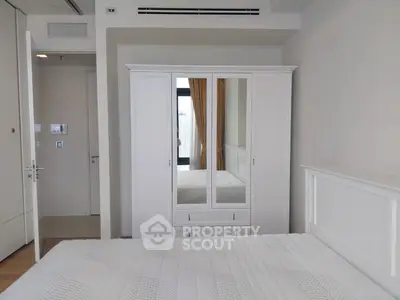 Spacious bedroom with white wardrobe and modern decor