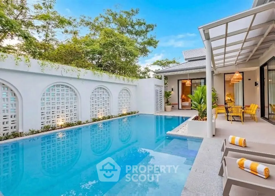 Luxurious villa with private pool and modern outdoor seating area, perfect for relaxation.