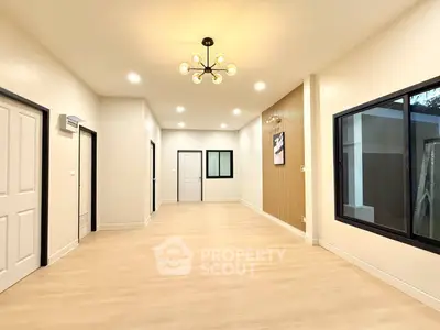 Spacious modern living room with elegant lighting and large windows