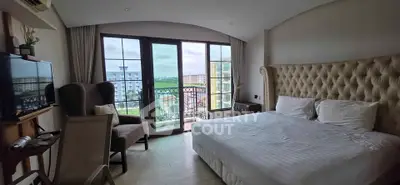 Luxurious bedroom with elegant decor and balcony view in modern apartment.
