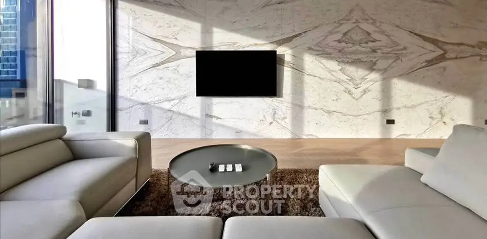 Luxurious modern living room with sleek furniture and marble accent wall