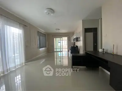Spacious modern living room with sleek design and ample natural light