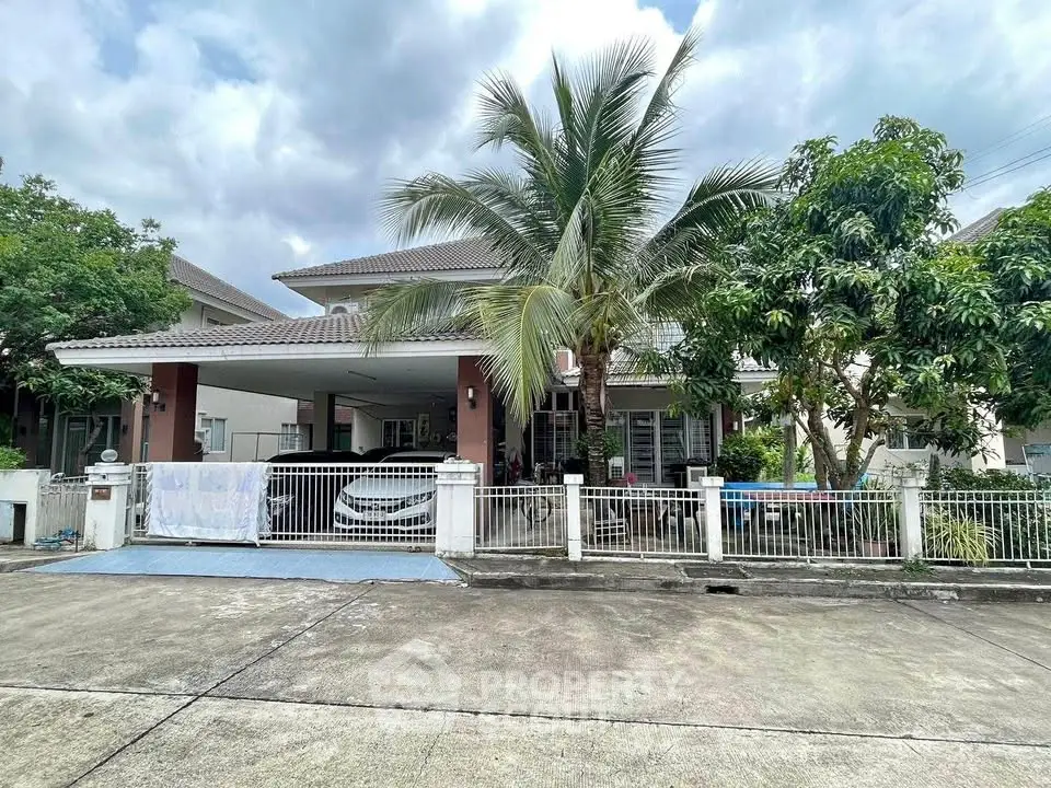 Charming suburban house with lush greenery and spacious driveway