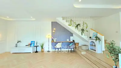 Spacious modern living room with stylish staircase and elegant decor