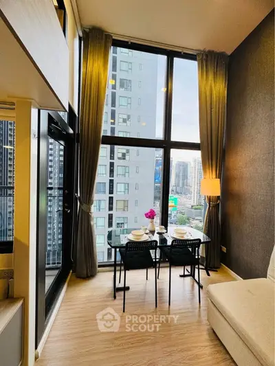 Modern high-rise apartment with floor-to-ceiling windows and city view, featuring a cozy dining area.