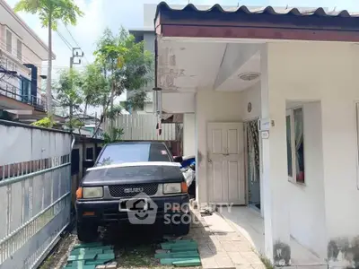 Charming single-story home with carport and lush greenery in a quiet neighborhood.