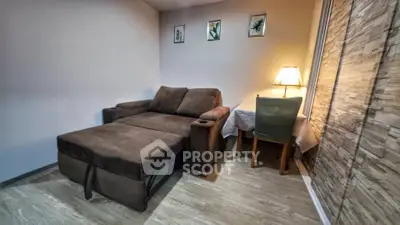 Cozy living room with plush brown sofa and ambient lighting, perfect for relaxation.