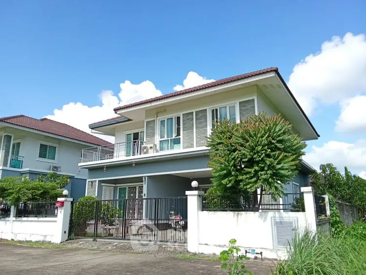 Stunning two-story house with spacious balcony and lush greenery, perfect for family living.