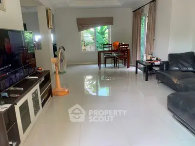 Spacious living room with modern furniture and large windows offering natural light.