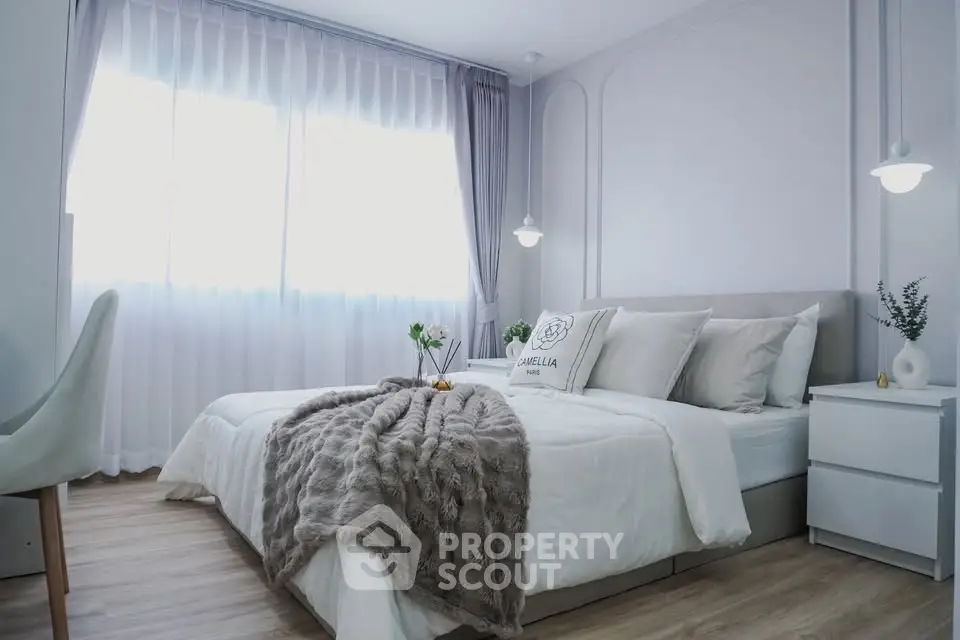 Elegant bedroom with cozy decor and natural light