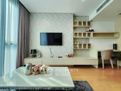 Modern living room with wall-mounted TV, elegant decor, and stylish shelving.