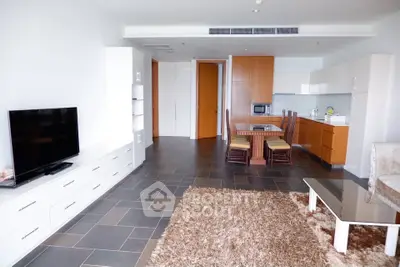 Spacious modern living room with open kitchen and stylish decor