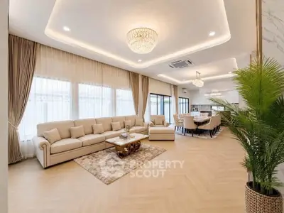 Luxurious open-plan living room with elegant chandelier and modern decor