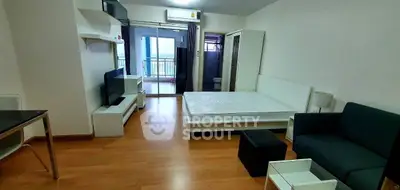 Modern studio apartment with balcony and stylish furnishings.