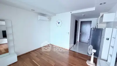 Spacious modern living room with wooden flooring and air conditioning