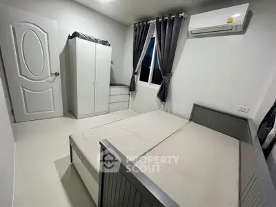 Modern bedroom with sleek design, featuring a bed, wardrobe, and air conditioning for ultimate comfort.
