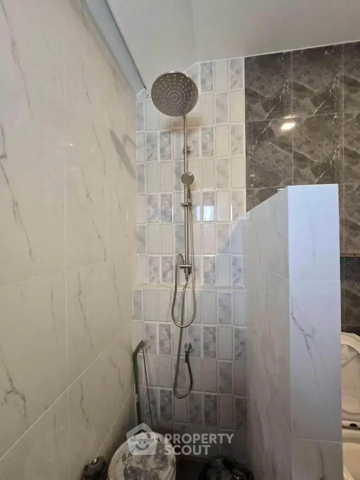 Modern bathroom with sleek shower design and marble tiles