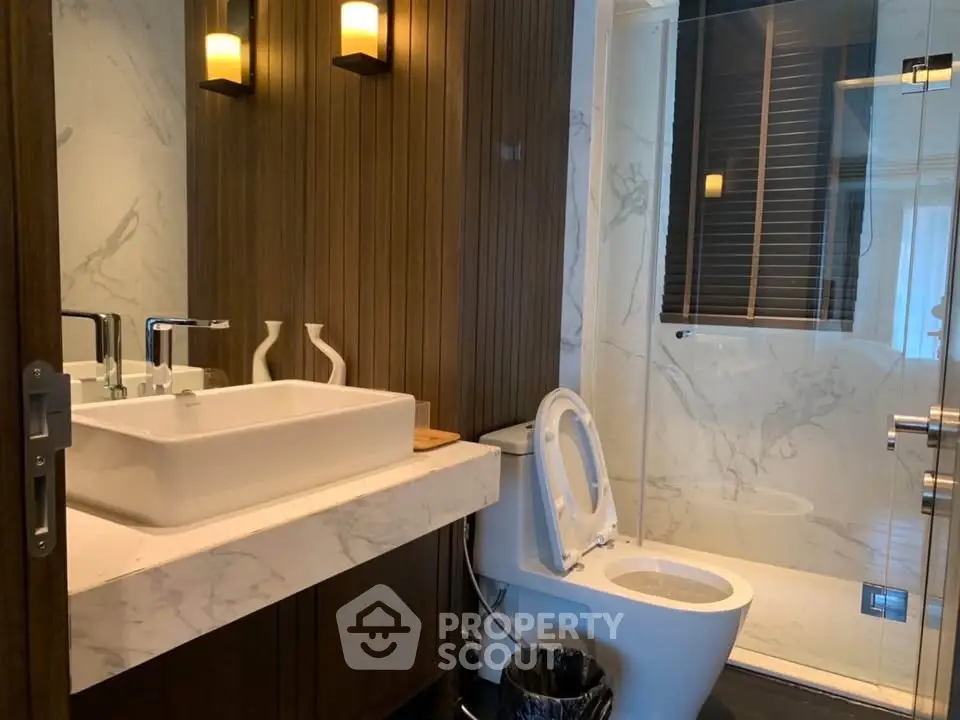 Luxurious modern bathroom with marble sink and glass shower enclosure