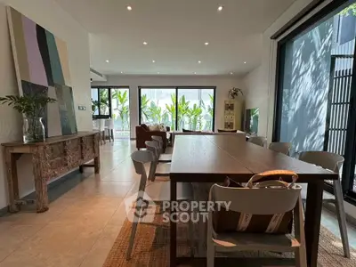 Spacious modern dining area with large windows and stylish decor, perfect for entertaining.