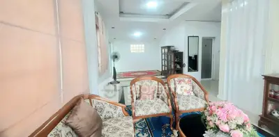 Spacious living room with elegant floral furniture and modern decor