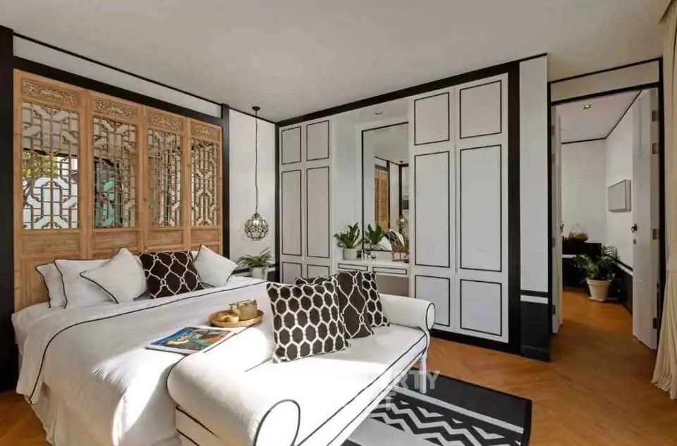 Luxurious bedroom with elegant decor and stylish furnishings, featuring a cozy seating area and intricate wall designs.