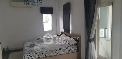 Cozy bedroom with natural light and modern decor, featuring a comfortable bed and stylish window treatments.