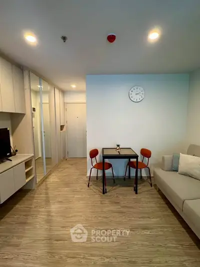 Modern living room with stylish furniture and wooden flooring in a cozy apartment.
