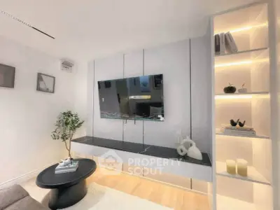 Modern living room with sleek TV setup and stylish shelving