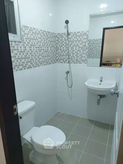 Modern bathroom with sleek fixtures and stylish tile design.