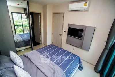 Modern bedroom with air conditioning and balcony view in urban apartment