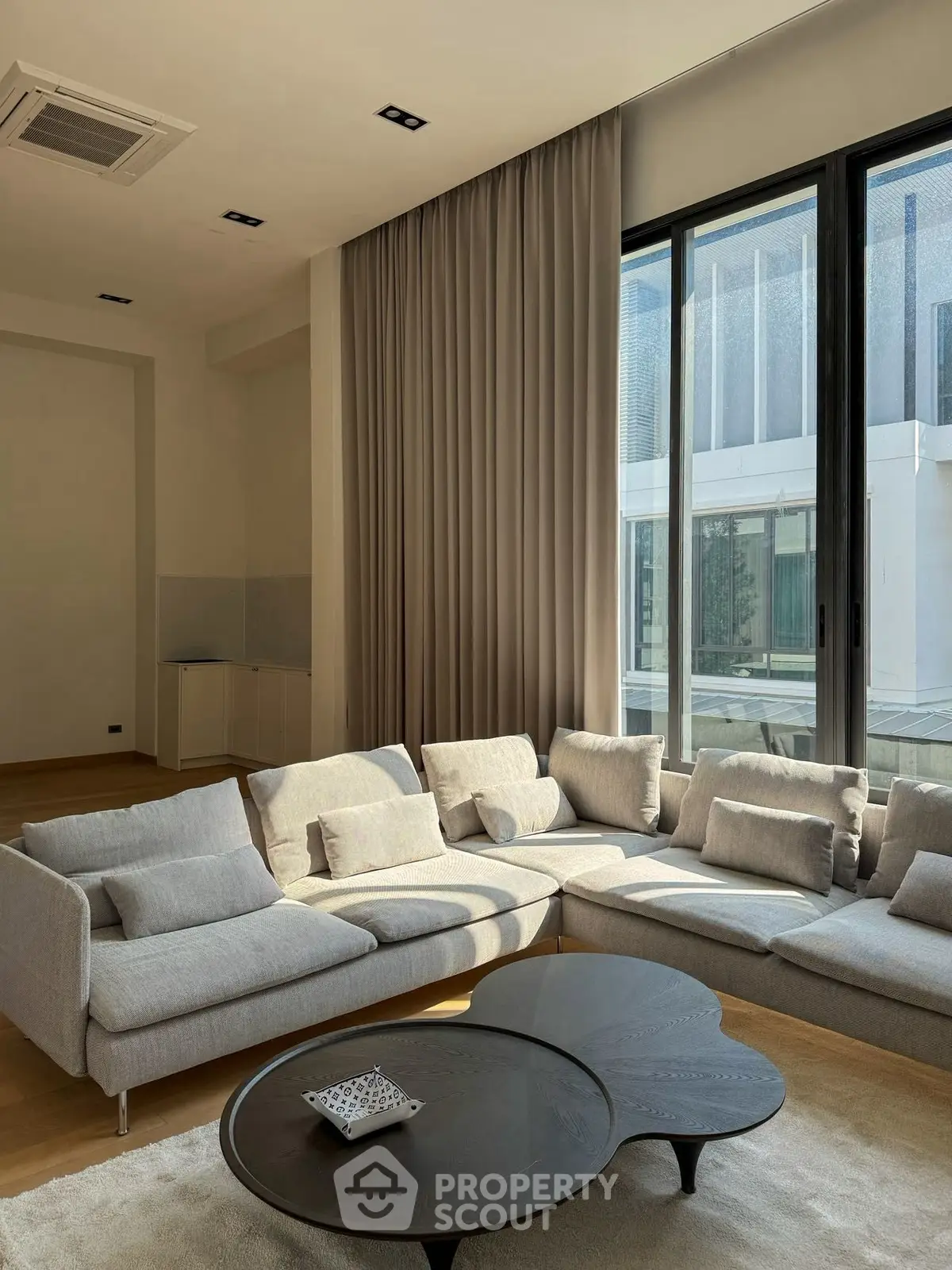 Spacious modern living room with large windows and stylish furniture