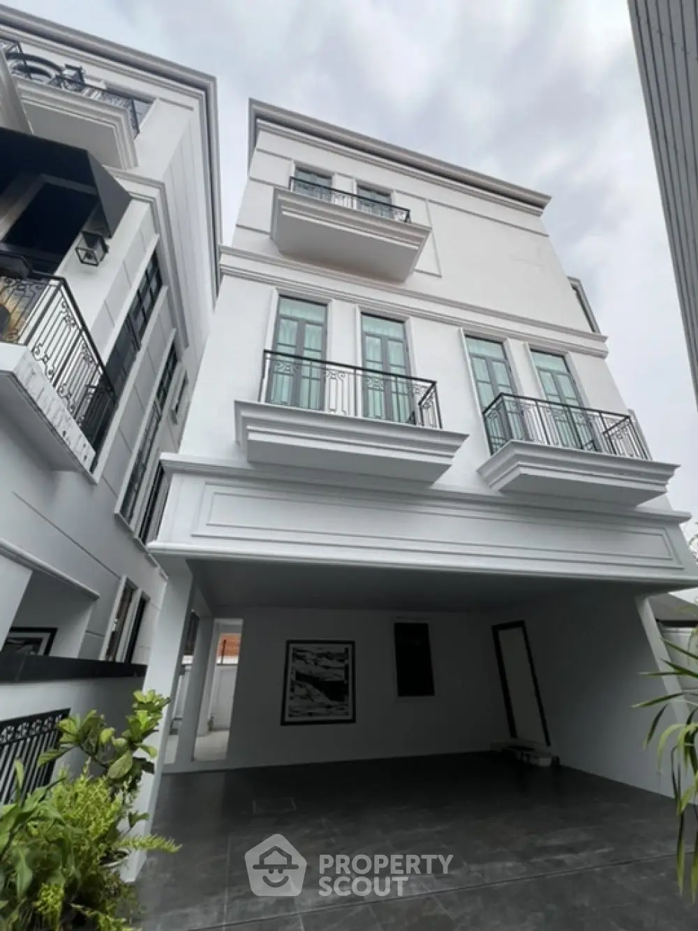 Elegant multi-story residential building with spacious balconies and a modern design, nestled in a serene neighborhood, perfect for urban living.