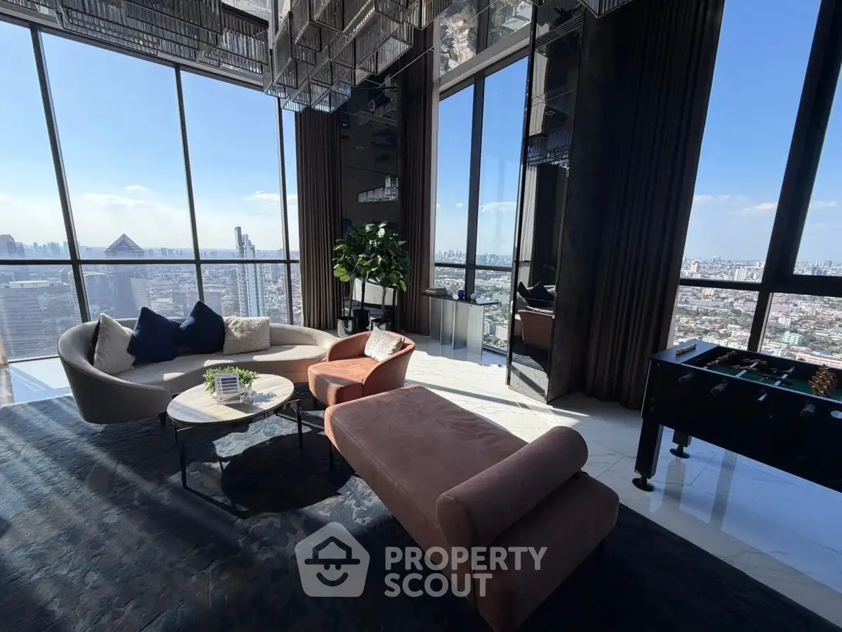Luxurious high-rise living room with panoramic city views and modern furnishings.