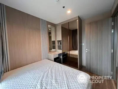 Modern bedroom with stylish wood paneling and mirrored wardrobe