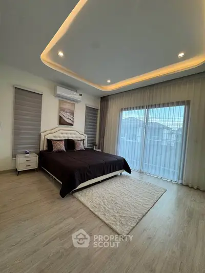 Luxurious bedroom with modern lighting and large windows for natural light.