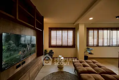 Spacious living room with modern decor and large windows