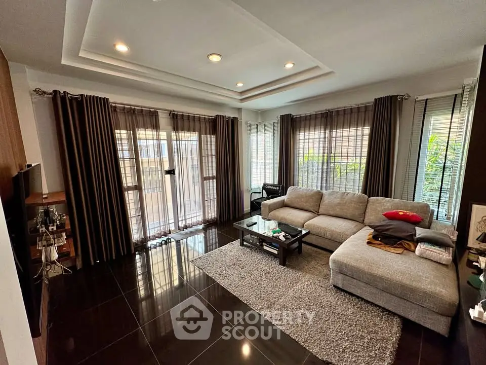 Spacious modern living room with large windows and stylish decor