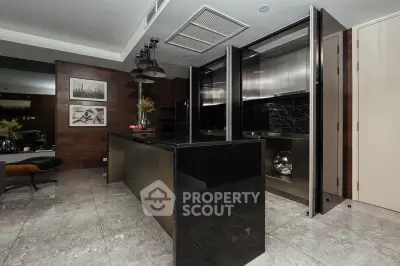 Luxurious modern kitchen with sleek black countertops and stainless steel appliances, perfect for gourmet cooking.